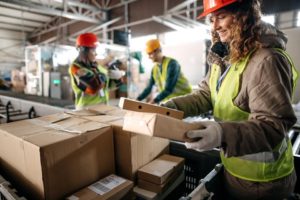 workers inspecting packages - supply chain security